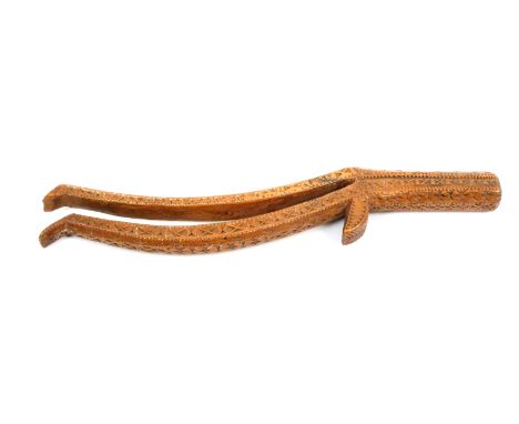 An unusual fruitwood knitting stick scratch dated ‘1773’ probably Welsh, of double scroll form with elaborate chip carved dec