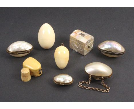 Eight thimble cases comprising four mother of pearl egg form examples with gilt hinge mounts, two ivory eggs, a mother of pea