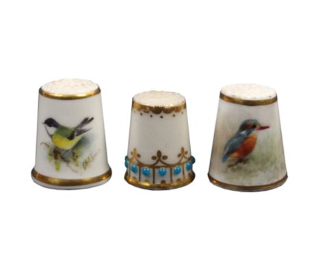 Three Worcester porcelain thimbles comprising a jewelled and gilded example, and two Royal Worcester black mark examples each