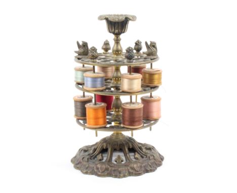 A mid Victorian brass reel stand, the pierced and scroll cast base below three pierced circular tiers below a vase form finia