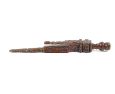 A 19th Century carved and stained knitting stick, probably Welsh, of twin prong for with flat back, trellis carved and perhap