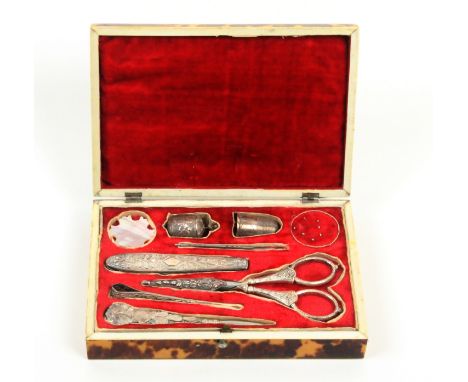 A tortoiseshell rectangular sewing box, circa 1830 with a full complement of fittings, the cushion lid with white metal table