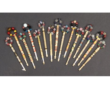 Fifteen 19th Century bone lace bobbins five coloured dominoes, two Porthole examples, three with coloured beadwork, four Fair