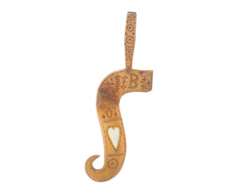 A fruitwood knitting stick of exaggerated scroll form chip carved with a flowering pot, the initials ‘JB’, a bone heart and g