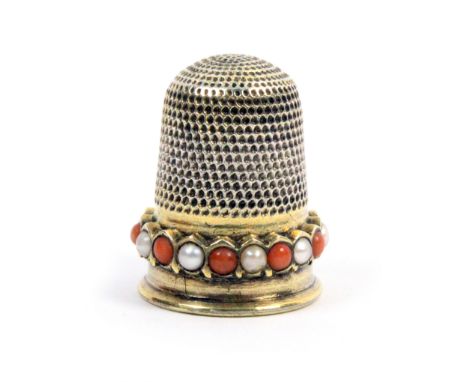 A 19th Century gold thimble, the frieze with a band of alternate coral and pearl coloured stones over a plain rim Internal la
