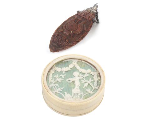 A 19th Century corozo scent flask and an ivory patch box, the flask carved with flowers and trophies, silver stopper and hang