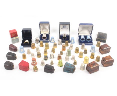 A quantity of thimbles and thimble boxes including ceramic Royal commemoratives Wedgwood, aluminium advertising, brass etc to