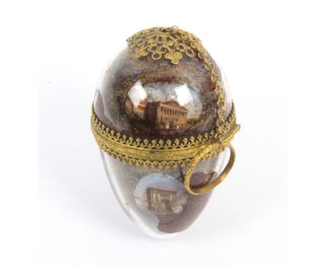 A rare glass egg form finger etui attributed to Palais Royal, circa 1860, the egg on a ring and chain to a gilt top mount, el