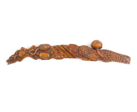 A large knitting stick late 19th Century of curved form, continental, one side carved with fruiting and flowering branches 28