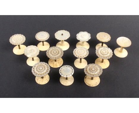 Thirteen mother of pearl top reel holders including a set of five, a pair and six variant, largest 3.5cm dia (13)