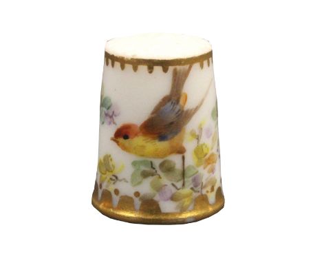 A Worcester porcelain thimble painted with a bird and flowering branches below a line and dot gilt band, the frieze with gilt