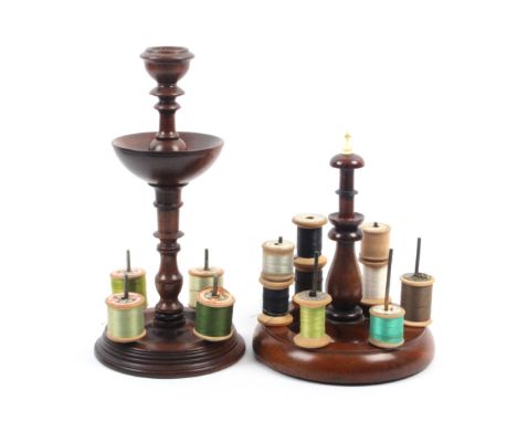 Two 19th Century mahogany reel stands comprising a circular base example with four reel spikes below a pin dish and turned to