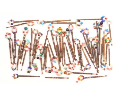 Fifty 19th Century turned wooden lace bobbins including leopards, butterflies and tigers including one attributed to Bobbin B
