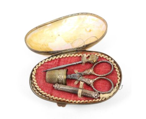 A French mother of pearl egg form etui for a child or doll, circa 1890, the shell in gilt frame hinge mount, the cloth interi