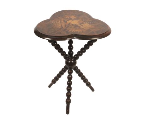 A scarce Fern ware gipsy table, the clover leaf top with silhouette ferns on a brown ground, on bobbin turned cross form legs