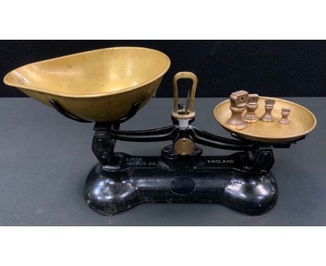 A set of Libra scale Co cast iron and brass scales, four bell weights 