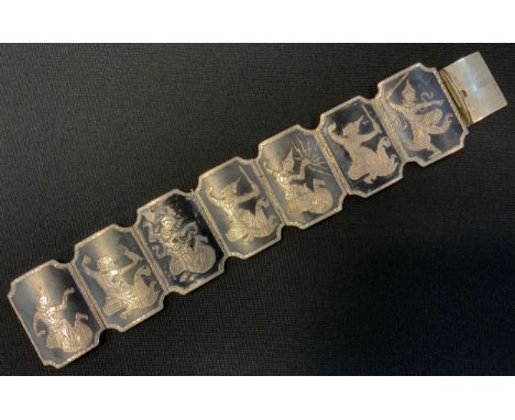 A Siam silver coloured metal and black enamel seven panel bracelet, Dancing figures, compression clasp, unmarked, 57.9g gross