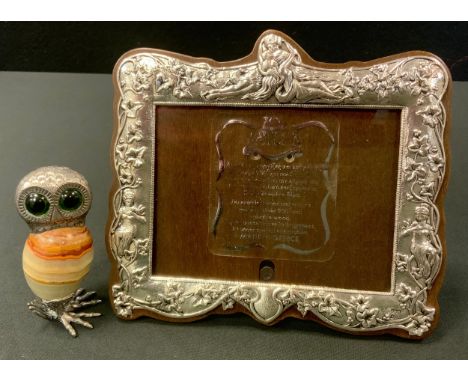 A Greek silver coloured metal easel photograph frame, embossed with figures and scrolls, 15cm x 17cm, marked 950;  a novelty 