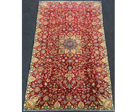 A Persian 'Ishfahan' rug / carpet, knotted in tones of pale blue, cream, and red, central lotus form medallion within a field