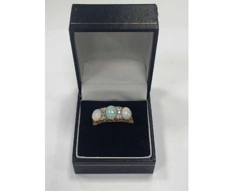 IMPRESSIVE VICTORIAN STYLE OPAL AND DIAMOND RING set with three large oval cabochon opals, interspersed with six old cut diam