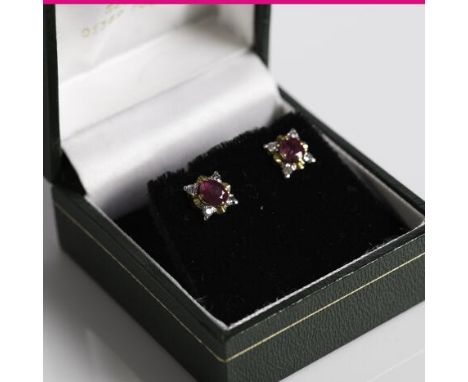 PAIR OF RUBY AND DIAMOND CLUSTER EARRINGS
each set with an oval ruby measuring approximately 4.85mm x 4.35mm, surrounded by b