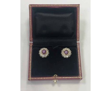 PAIR OF RUBY AND DIAMOND CLUSTER EARRINGS each set with a central cabochon ruby, surrounded by old cut diamonds, the diamonds