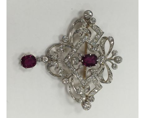FINE RUBY AND DIAMOND HOLBEIN
of openwork form, with a central cushion cut ruby and a cushion cut ruby drop, the rubies total