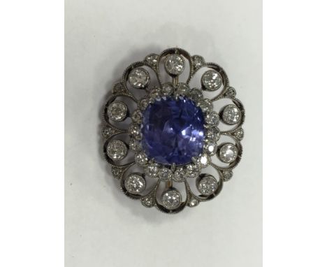 SAPPHIRE AND DIAMOND BROOCH
the cushion cut sapphire approximately 9.32 carats, with an accompanying GCS certificate stating 