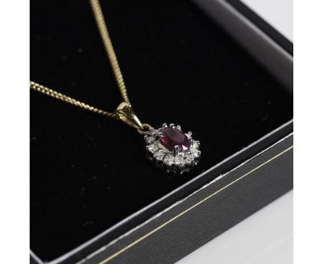 RUBY AND DIAMOND CLUSTER PENDANT
the central oval ruby approximately 6.03mm x 4.21mm, surrounded by a row of brilliant cut di