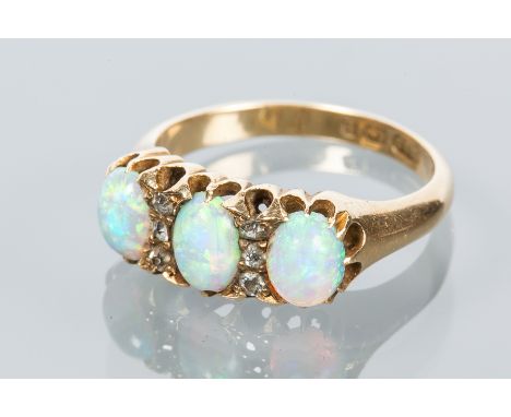 OPAL AND DIAMOND RING
with three oval opals interspersed with rose cut diamonds, hallmarked for eighteen carat gold, size N