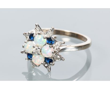 SAPPHIRE, DIAMOND AND OPAL CLUSTER RING
set with four round cabochon cut opals, interspersed with brilliant cut sapphires and