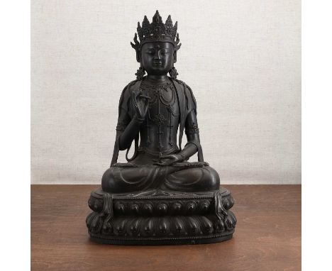 A Chinese bronze bodhisattva,Ming dynasty (1368-1644), seated cross-legged on a double lotus pedestal, his eyes downcast with