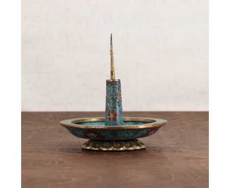 A Chinese cloisonné candlestick,Qing dynasty (1644-1911), the circular drip tray surmounted by a metal pricket, enamelled wit