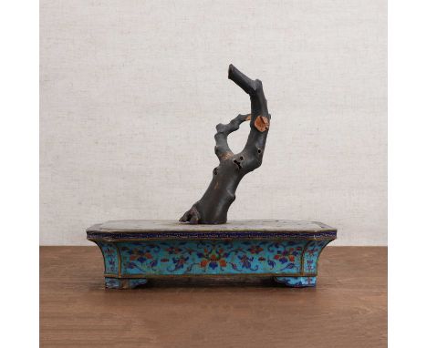 A Chinese painted enamel planter,Qing dynasty (1644-1911), of octagonal form on four bracket feet, painted with scrolling lot