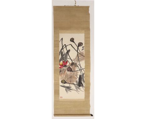 A Chinese hanging scroll,20th century, in the style of Qi Baishi (1864-1957), painted with a lotus flower with leaves and see