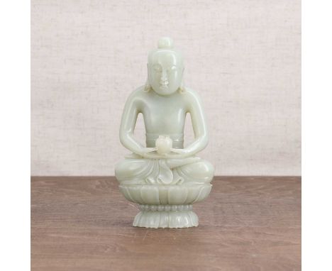 A Chinese jade Buddha,20th century, seated cross-legged on a double lotus pedestal, holding a jar in his hands,15.5cm highCon