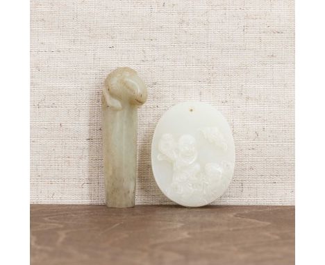 A Chinese jade plaque,20th century, carved with Liu Hai and a three-legged toad,5.3cm long, anda jade handle,the finial in th