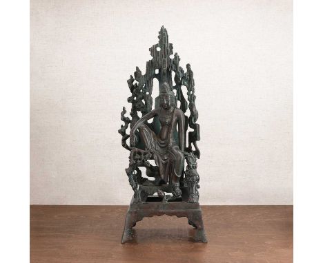 A Chinese bronze bodhisattva,with his right hand resting on his raised knee and the left hand supporting him to the side, his