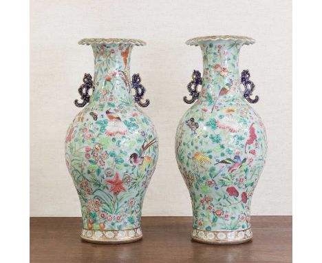A pair of Chinese Canton famille rose vases,late 19th century, each of baluster form with a lobed flared mouth, painted with 