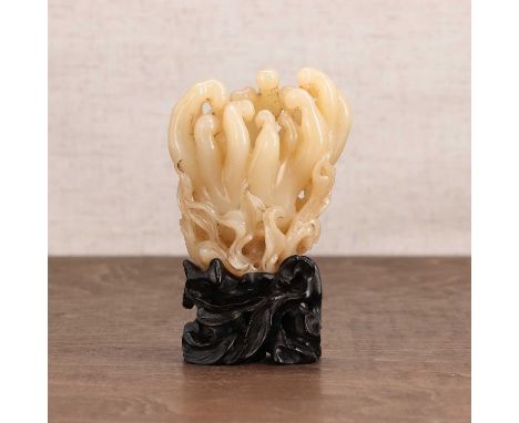 A Chinese jade carving,20th century, in the shape of a finger citron with leaves,8.5cm high, wood stand (2)Condition ReportNo