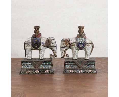 A pair of Chinese cloisonné elephants,19th century, each standing carrying a vase on its back, the saddlecloth decorated with