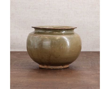 A Chinese celadon jar,Song dynasty (960-1279), in the style of Yaozhou ware, the globular body rising from a circular foot to