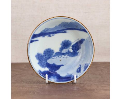 A Chinese blue and white saucer,Kangxi (1662-1722), the rounded sides rising from a circular foot, painted with a literatus h
