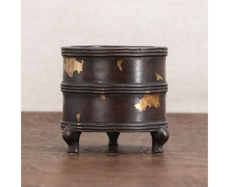 A Chinese gilt-bronze incense burner,the cylindrical body supported on three cabriole feet, the exterior with gilt splash dec