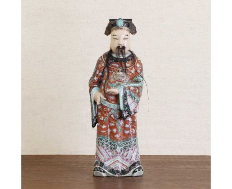 A Chinese famille rose figure,19th century, of Lu Lao wearing a long robe painted with dragons amongst clouds, against a red 