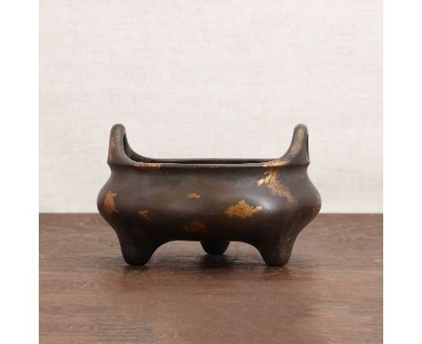 A Chinese gilt-bronze incense burner,of compressed globular form on three stud feet, two loop handles to the rim, all with gi