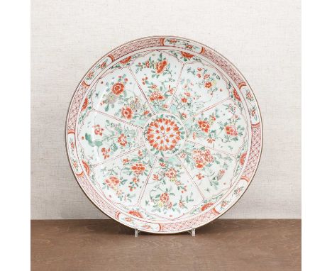 A Chinese famille verte charger,Kangxi (1662-1722), the rounded sides rising from a circular foot, painted with peony, lotus 