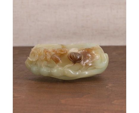 A Chinese jade brush washer,20th century, in the shape of a lotus flower supported by a lotus root, the side pierced and carv