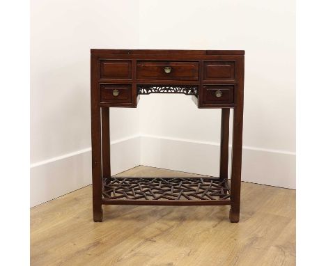 A Chinese hardwood dressing table, 20th century, the rectangular top with a pair of folding compartments enclosing lift-out t