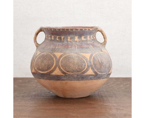 A Chinese pottery jar,Neolithic period (c.6500-1700 BC), the globular body with a wide everted neck and twin loop handles, pa